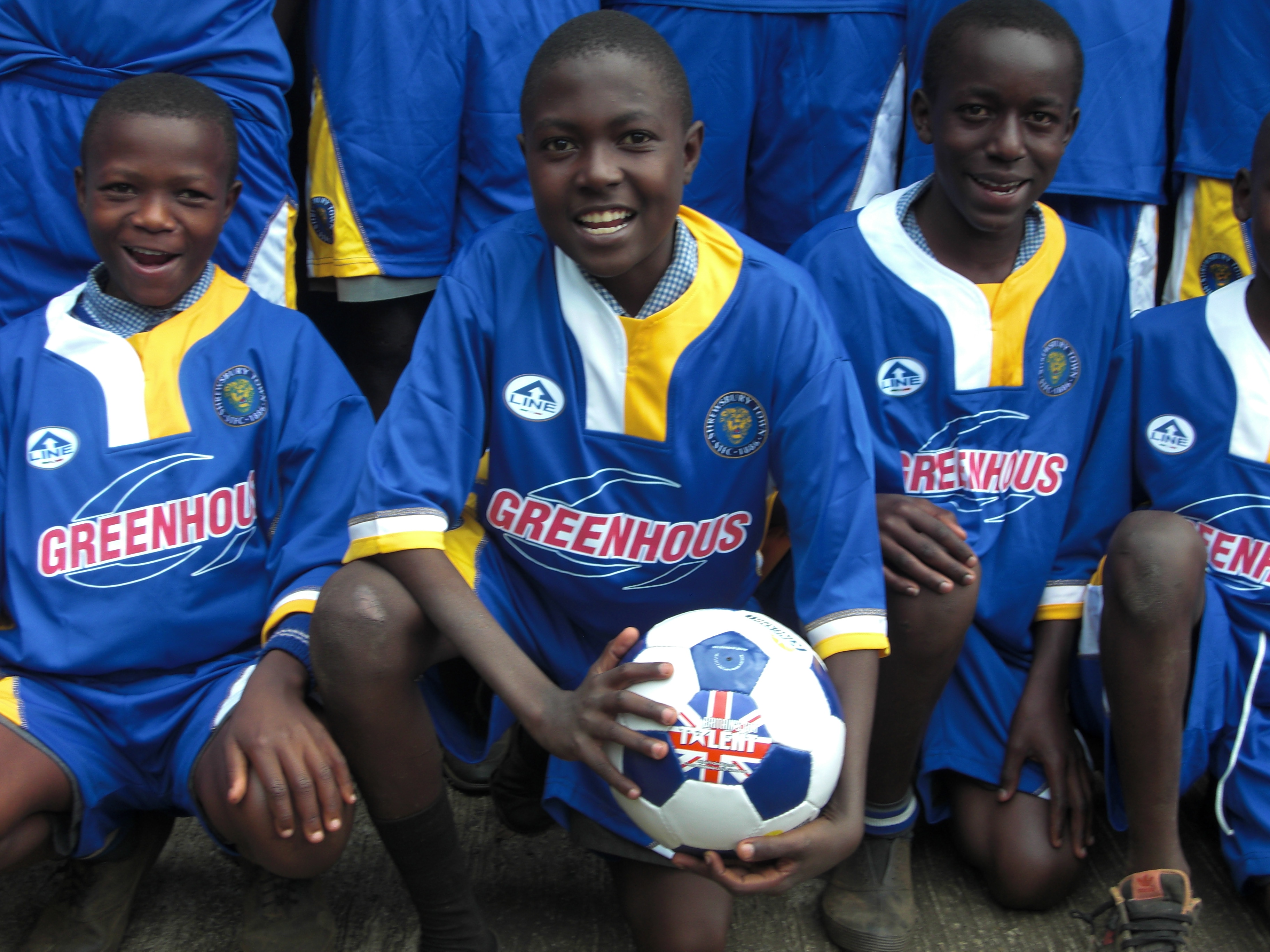 Children and young people wearing Shrewsbury Town Football Club kit.